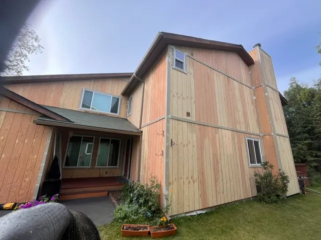 Home exterior with covered porch at dusk