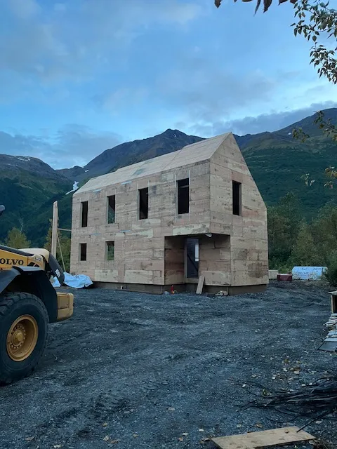 Framed exterior walls of a two-story home at dusk