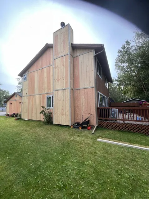 Finished wood siding and chimney detail